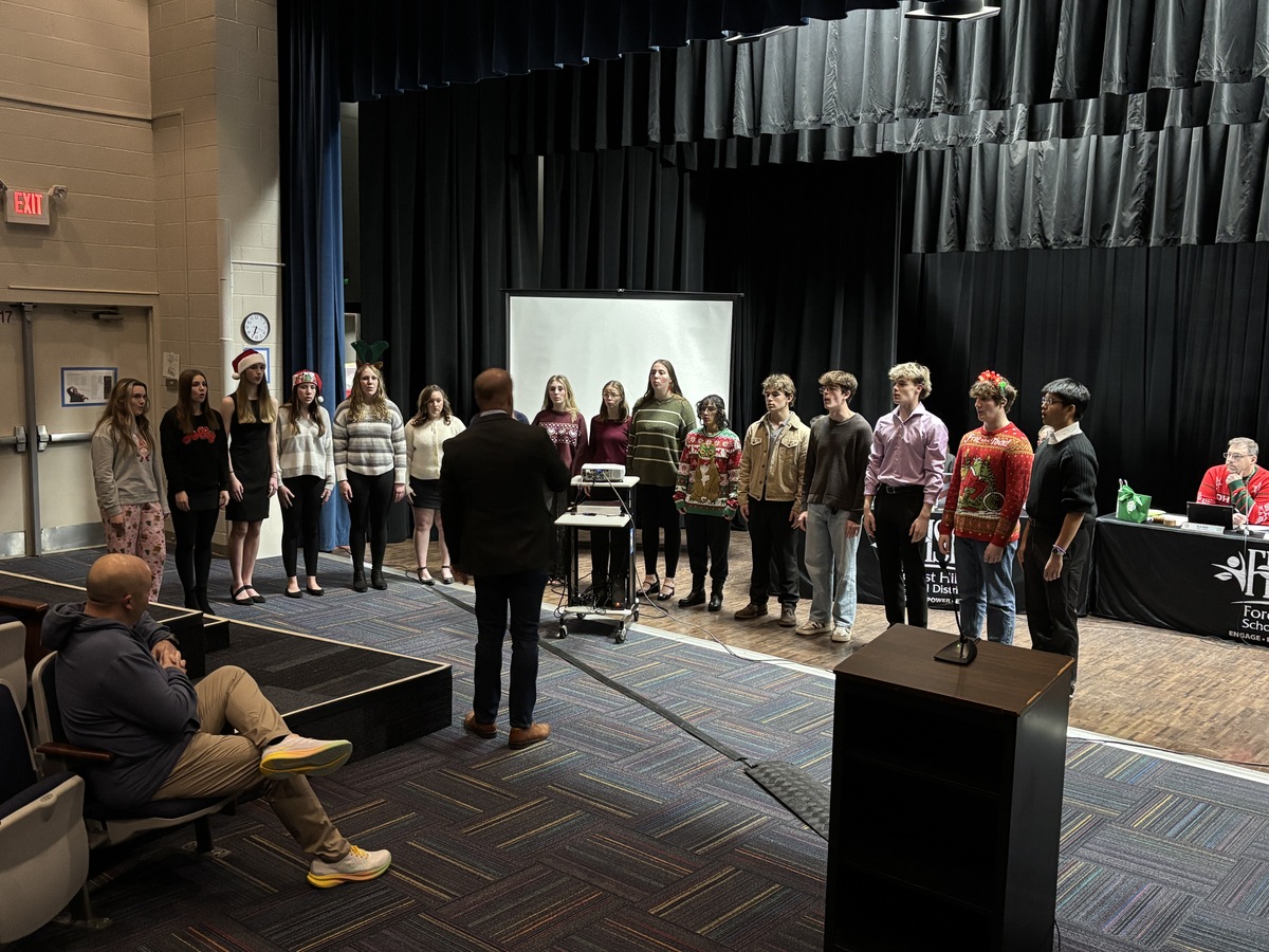 AHS Chamber Choir performs in an auditorium